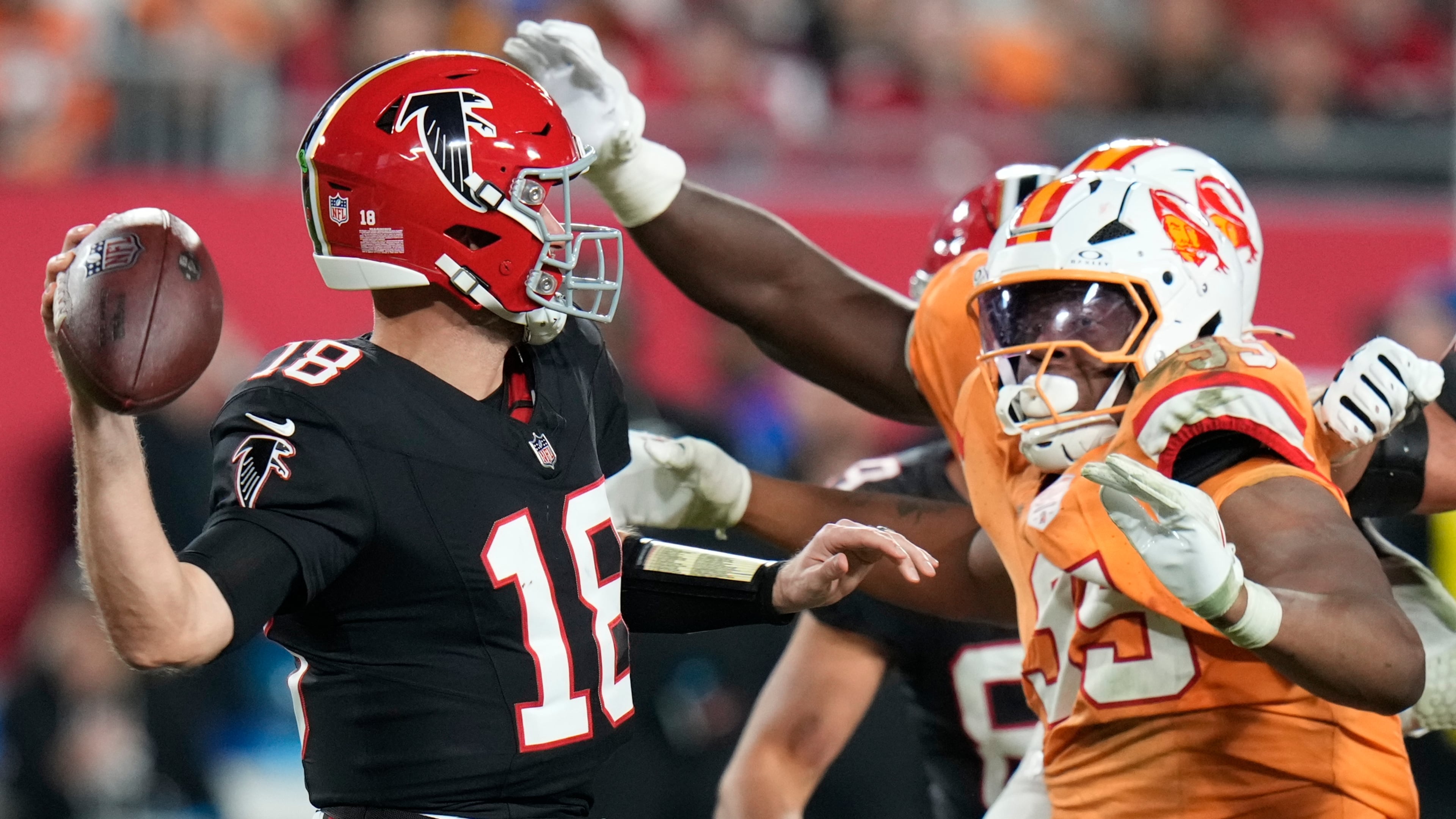 Falcons quarterback Kirk Cousins (left) is pressured by Buccaneers defensive end Elijah Roberts on Thursday, Dec. 11, 2025, in Tampa, Fla. For the third time in three starts with the Falcons, Cousins guided them to victory. (Chris O'Meara/AP)