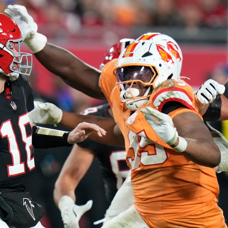 Falcons quarterback Kirk Cousins (left) is pressured by Buccaneers defensive end Elijah Roberts on Thursday, Dec. 11, 2025, in Tampa, Fla. For the third time in three starts with the Falcons, Cousins guided them to victory. (Chris O'Meara/AP)