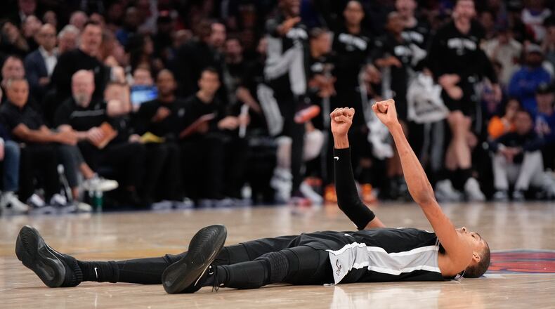 San Antonio Spurs forward Victor Wembanyama lies on the court after a shot during second half of Game 3 of the NBA Finals basketball series against the New York Knicks, Monday, June 8, 2026, in New York. (AP Photo/Ross D. Franklin)