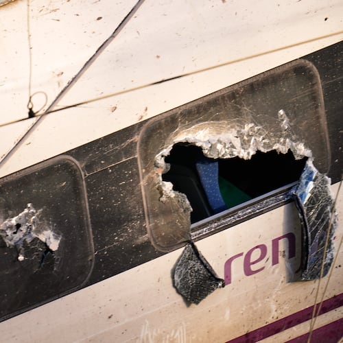 Broken windows of a crashed train are photographed at the site of a train collision in Adamuz, southern Spain, Monday, Jan. 19, 2026. (AP Photo/Manu Fernandez)