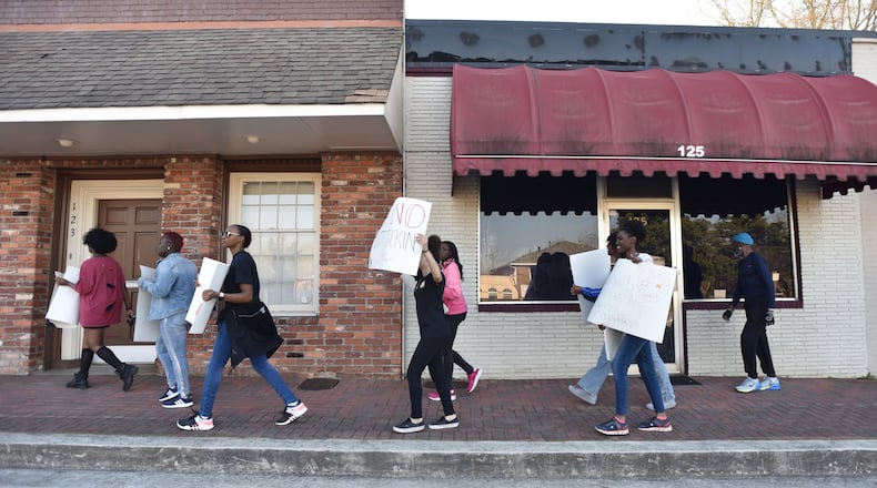 Students holding signs walk through downtown Jonesboro to demonstrate tobacco’s deadly effects on March 20, 2019. Youth use of electronic cigarettes “has reached an epidemic proportion,” the leader of the Food and Drug Administration and the U.S. surgeon general have said recently. HYOSUB SHIN / HSHIN@AJC.COM