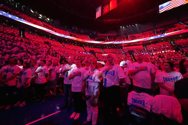 Fans listen as the national anthem plays before Game 1 of the NBA Finals basketball series between the Indiana Pacers and the Oklahoma City Thunder Thursday, June 5, 2025, in Oklahoma City. (AP Photo/Julio Cortez)