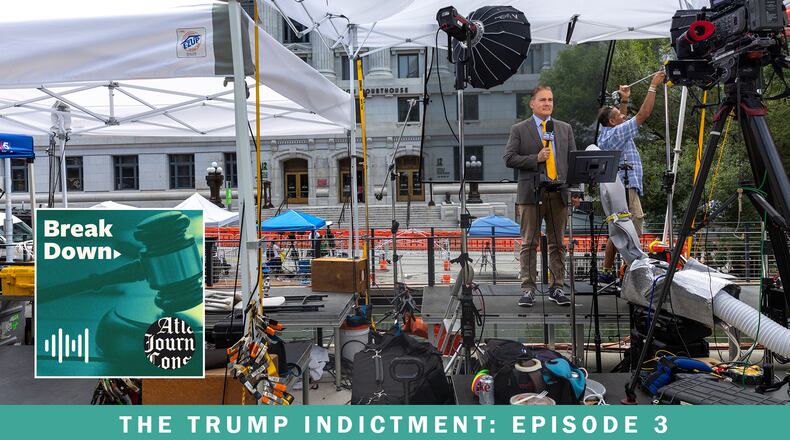 A Fox News reporter stands outside the Fulton County Courthouse the day after a grand jury made its indictment against former President Donald Trump. The AJC's 'Breakdown' podcast examines the aftermath of the indictment and efforts to move the case. (Arvin Temkar / arvin.temkar@ajc.com)