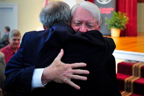 Michael Adams receives a hug after announcing his plans to step down on June 30, 2013 at the University of Georgia Chapel in Athens Ga., Thursday, May 3, 2012. (AP Photo/The Banner-Herald, AJ Reynolds)