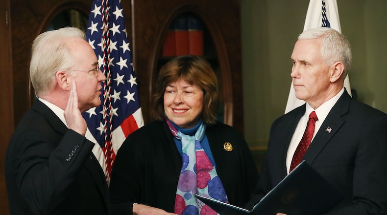 Vice President Mike Pence, right, administers the oath of office Friday to Tom Price to become the nation’s 23rd secretary of health and human services. Price’s wife, Betty, holds a Bible as the Roswell Republican takes the oath. (Photo by Mark Wilson/Getty Images)