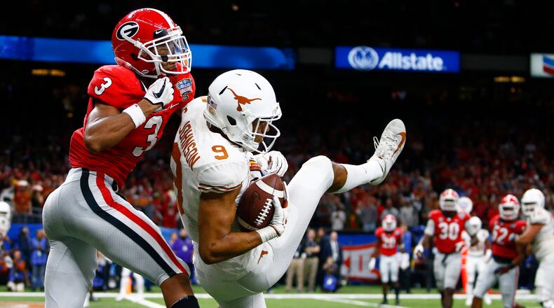 Texas wide receiver Collin Johnson (9) pulls in a 2-point conversion against Georgia defensive back Tyson Campbell (3) during the second half of the Sugar Bowl NCAA college football game in New Orleans, Tuesday, Jan. 1, 2019. (AP Photo/Butch Dill)