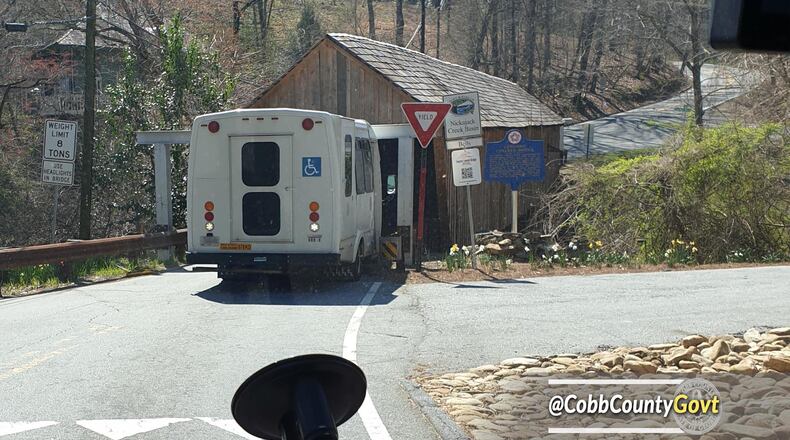 Cobb County's covered bridge on Concord Road experienced another close call Wednesday when a small bus crashed into metal beams designed to protect the structure.