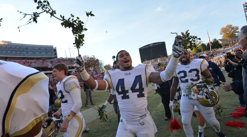 November 29, 2014 Athens - Georgia Tech Yellow Jackets players celebrate their 30-24 overtime win against Georgia with pieces of the Sanford Stadium hedges at Sanford Stadium in Athens on Saturday, November 29, 2014. In the 109th playing of the Tech-Georgia game, the No. 16 Yellow Jackets ended the No. 9 Bulldogs' five-game winning streak in the series with a 30-24 overtime win at Sanford Stadium Saturday afternoon. HYOSUB SHIN / HSHIN@AJC.COM