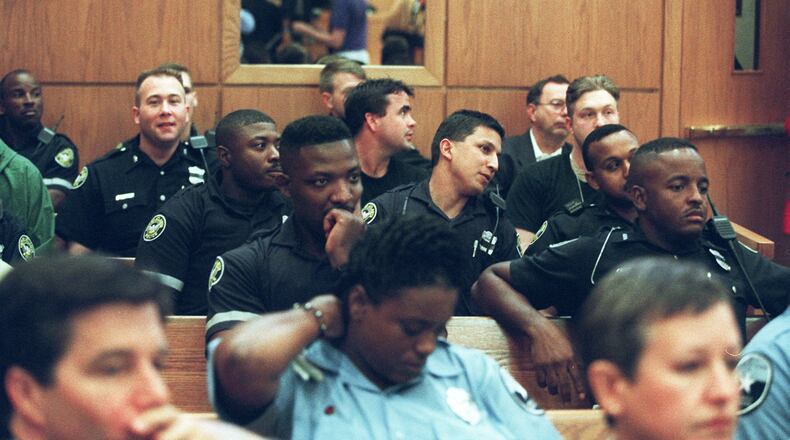 Atlanta Police Officers, sit patiently on Oct. 14, 1997 in Municipal Court in Atlanta, to hear the outcome from the arraignment of Gregory Paul Lawler, then accused of killing one Atlanta police officer and critically wounding another. (AJC Staff Photo/Dwight Ross Jr.) 10/97