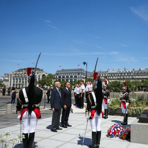 France's President Emmanuel Macron, center right, with Charles Dreyfus grandson of Alfred Dreyfus during a tribute ceremony to Captain Alfred Dreyfus on the first national day dedicated to the recognition of his innocence by the Court of Cassation in 1906, and the fight against the resurgence of antisemitism, 120 years later, on the Ile de la Cite near the Cour de Cassation in Paris, Sunday, July 12, 2026. (Thomas Samson/Pool Photo via AP)