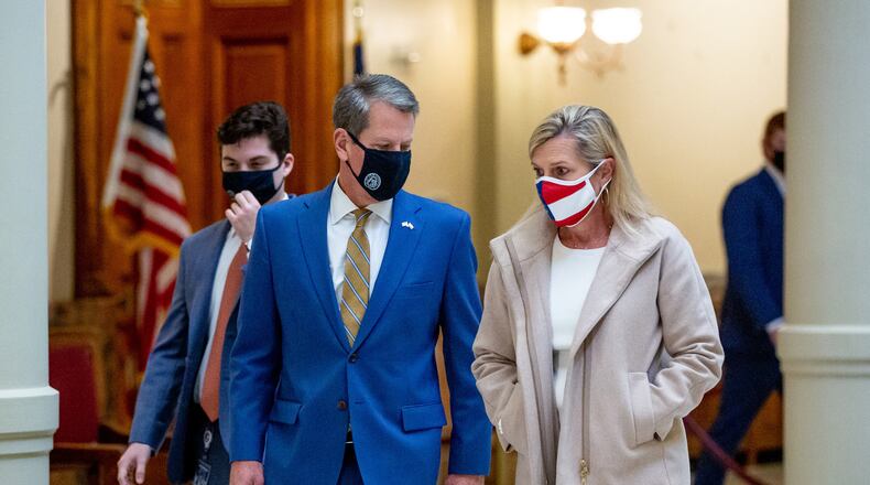 Gov. Brian Kemp and first lady Marty Kemp, shown talking in November before a press conference at the state Capitol, have led efforts targeting human trafficking, including three bills he signed into law on Tuesday. STEVE SCHAEFER / SPECIAL TO THE AJC