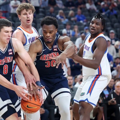 Arizona forwards Ivan Kharchenkov (8) and Tobe Awaka (30) contest for a rebound against Florida center Micah Handlogten, second from left, during the first half of an NCAA college basketball game, Monday, Nov. 3, 2025, in Las Vegas. (AP Photo/Ian Maule)