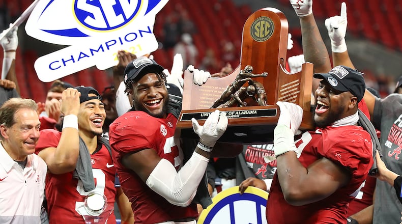 Alabama coach Nick Saban and his players (from left, Bryce Young, Will Anderson and Phidarian Mathis) celebrate as they are presented the SEC Championship trophy after defeating Georgia on Dec. 4, 2021, in Atlanta. (Curtis Compton / Curtis.Compton@ajc.com)