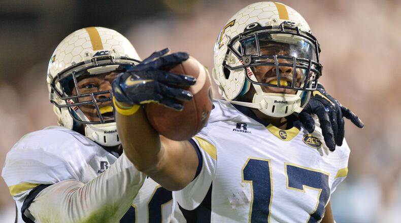 Georgia Tech defensive back Lance Austin celebrates his game-winning return of a blocked field goal with his teammate and brother, Lawrence Austin, as time expired in Saturday's game against Florida State. The Jackets won 22-16. (Hyosub Shin / hshin@ajc.com)