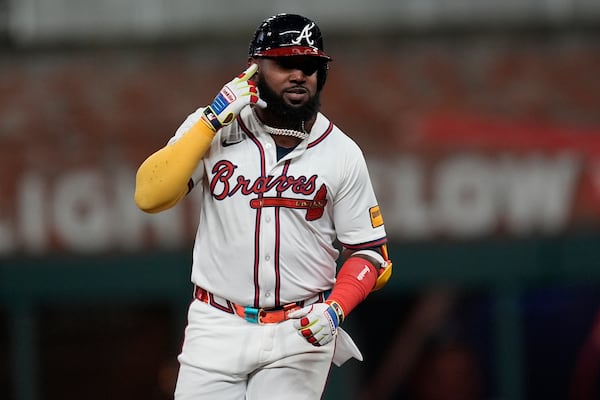 Atlanta Braves designated hitter Marcell Ozuna (20) celebrates his walk-off two-run homer against the Philadelphia Phillies in the 11th inning of a baseball game after a rain delay, Friday, April 11, 2025, in Atlanta. (AP Photo/Mike Stewart)