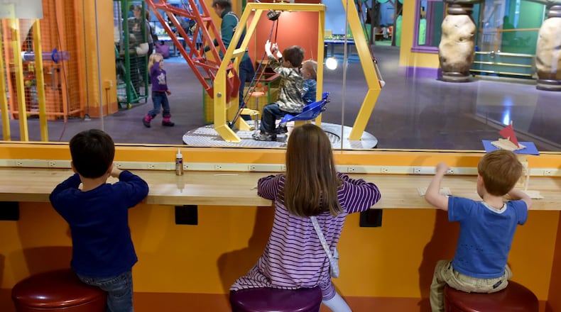 Kids build a project from wood sticks at the The Children's Museum of Atlanta.