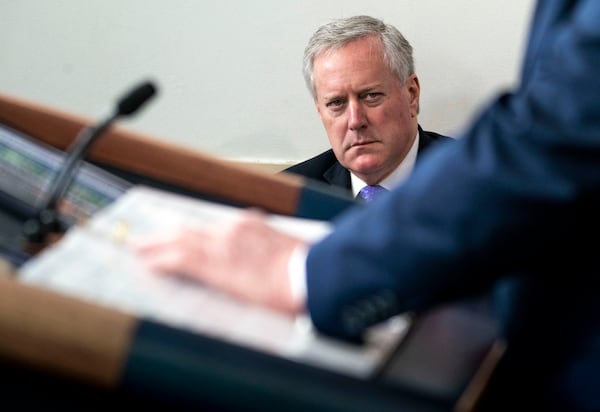 FILE — Mark Meadows, then the White House chief of staff, looks on as President Donald Trump speaks to reporters at the White House on July 2, 2020. Meadows, who was deeply involved in efforts to keep Trump in power after the 2020 election, has been ordered to travel to Atlanta to testify in a criminal investigation into election meddling.  (Doug Mills/The New York Times)