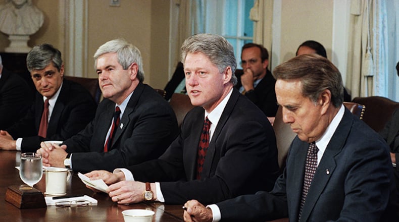 In this April 26, 1995 file photo, President Bill Clinton meets with congressional leaders in the Cabinet Room of the White House in Washington. From left are, Treasury Secretary Robert Rubin, House Speaker Newt Gingrich of Ga., the president, and Senate Majority Leader Bob Dole of Kansas. Disputes over spending and health care in a divided Washington have triggered shutdowns of the federal government in recent years and another one may be looming. Lawmakers in Congress are supposed to get their budget work done each year by Sept. 30, but little progress has been made so far.