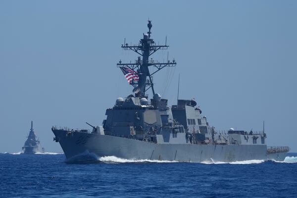 A US Navy USS Shoup (DDG86), right, and Japanese Maritime Self-Defence Force (JMSDF) frigate JS Noshiro, maneuver with Philippine Navy BRP Jose Rizal, not shown, during the Philippines United States Japan Multilateral Maritime Cooperative Activity off a disputed South China Sea shoal on Friday, March 28, 2025. (AP Photo/Aaron Favila)