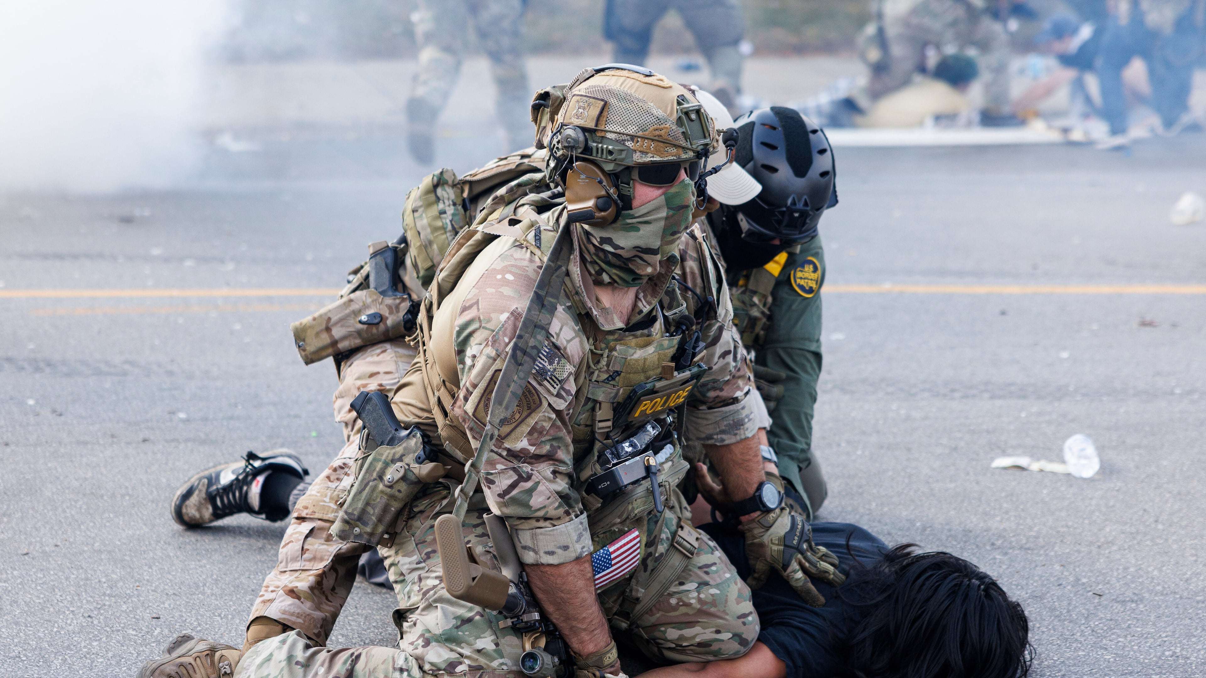 Federal officers hold down a protestor in the Brighton Park neighborhood of Chicago, on Saturday, Oct. 4, 2025, after protesters learned that U.S. Border Patrol shot a woman Saturday morning on Chicago's Southwest Side. (Anthony Vazquez/Chicago Sun-Times via AP)