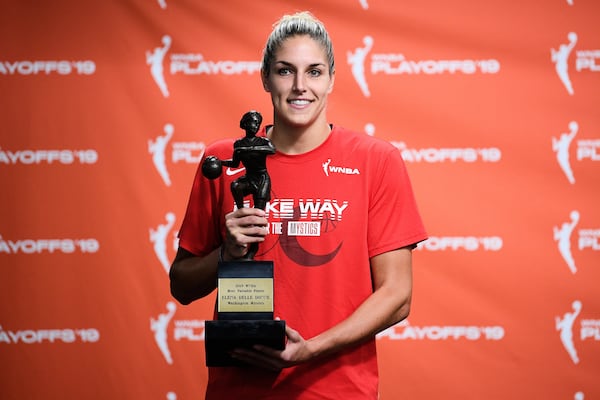FILE - Washington Mystics forward Elena Delle Donne poses with the 2019 WNBA most valuable player trophy at a press conference, Thursday, Sept. 19, 2019, in Washington. (AP Photo/Nick Wass, File)