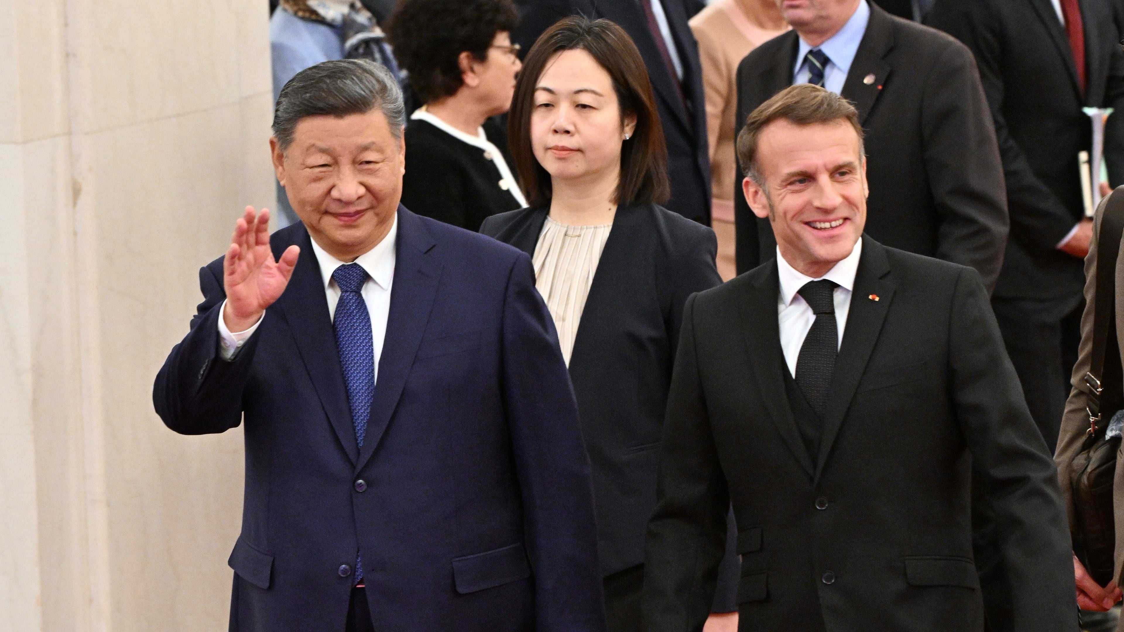 France's President Emmanuel Macron, right, and China's President Xi Jinping, left, walk during a state visit at the Great Hall of the People in Beijing Thursday, Dec. 4, 2025. (Adek Berry/Pool Photo via AP)