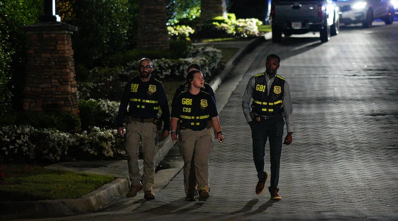 GBI officers investigate late Tuesday after Cobb police searched for a man wanted on an outstanding warrant for murder. The man, identified as 31-year-old Damian Strozier, has been located, according to Cobb police. (Ben Hendren for the AJC)