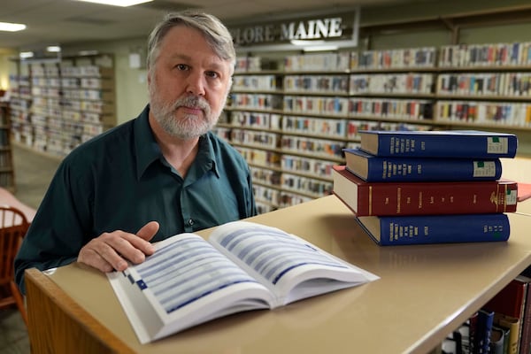 Chris Boynton, special services coordinator at the Maine State Library works in the library's temporary location, Wednesday, May 7, 2025, in Augusta, Maine. (AP Photo/Robert F. Bukaty)