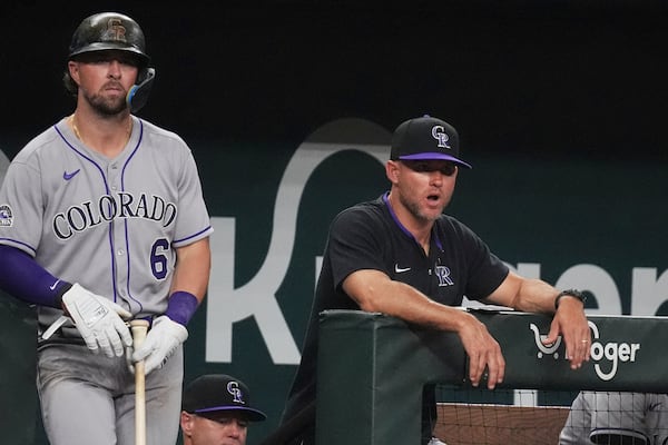 Colorado Rockies interim manager Warren Schaeffer, right, looks on as Kyle Farmer (6) prepares to bat during the sixth inning of a baseball game against the Texas Rangers, Wednesday, May 14, 2025, in Arlington, Texas. (AP Photo/LM Otero)