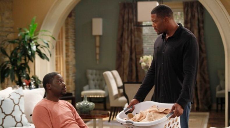 BROTHERS: Chill (Daryl Chill Mitchell, L) and Mike (Michael Strahan, R) are forced to help out around the house in the BROTHERS episode "House Rules/Anniversary" airing as part of the one-hour series premiere Friday, Sept. 25 (8:30-9:00 PM ET/PT) on FOX. ©2009 Fox Broadcasting Co. Cr: Greg Gayne/FOX