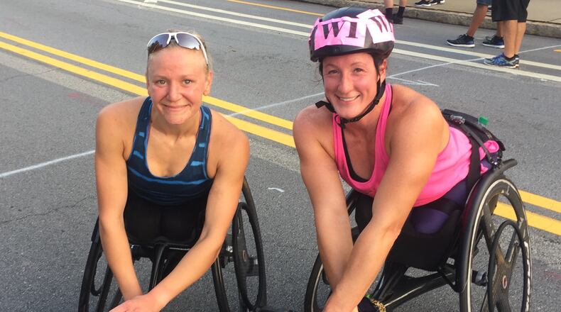 Susannah Scaroni, winner of the 2018 AJC Peachtree Road Race wheelchair division, poses with friend and runner-up Tatyana McFadden. (Gabe Burns/AJC)