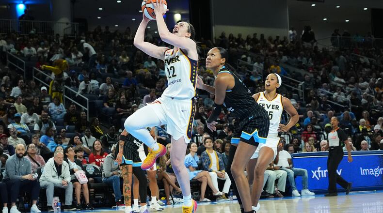 Indiana Fever guard Caitlin Clark, center left, drives to the basket past Chicago Sky forward/center Azura Stevens, center right, during the first half of a WNBA basketball game Sunday, Aug. 23, 2026, in Chicago. (AP Photo/Nam Y. Huh)