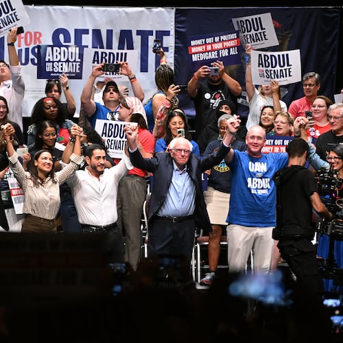 From left foreground, Michigan state Rep. Donavan McKinney, D-Detroit, U.S. Rep. Alexandria Ocasio-Cortez, D-N.Y., Michigan Democratic U.S. Senate primary candidate Abdul El-Sayed, U.S. Sen. Bernie Sanders, I-VT., United Auto Workers President Shawn Fain, and U.S. Rep. Rashida Tlaib, D-Mich. join hands together following a campaign rally for El-Sayed, Saturday, July 18, 2026, in Detroit. (AP Photo/Jose Juarez)