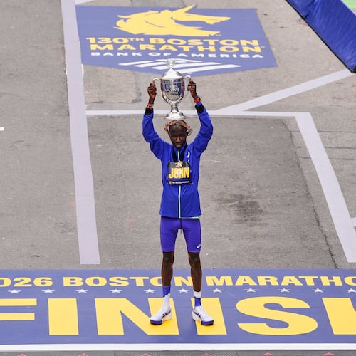 John Korir of Kenya, hoist the trophy after winning the Boston Marathon, Monday, April 20, 2026, in Boston. (AP Photo/Charles Krupa)