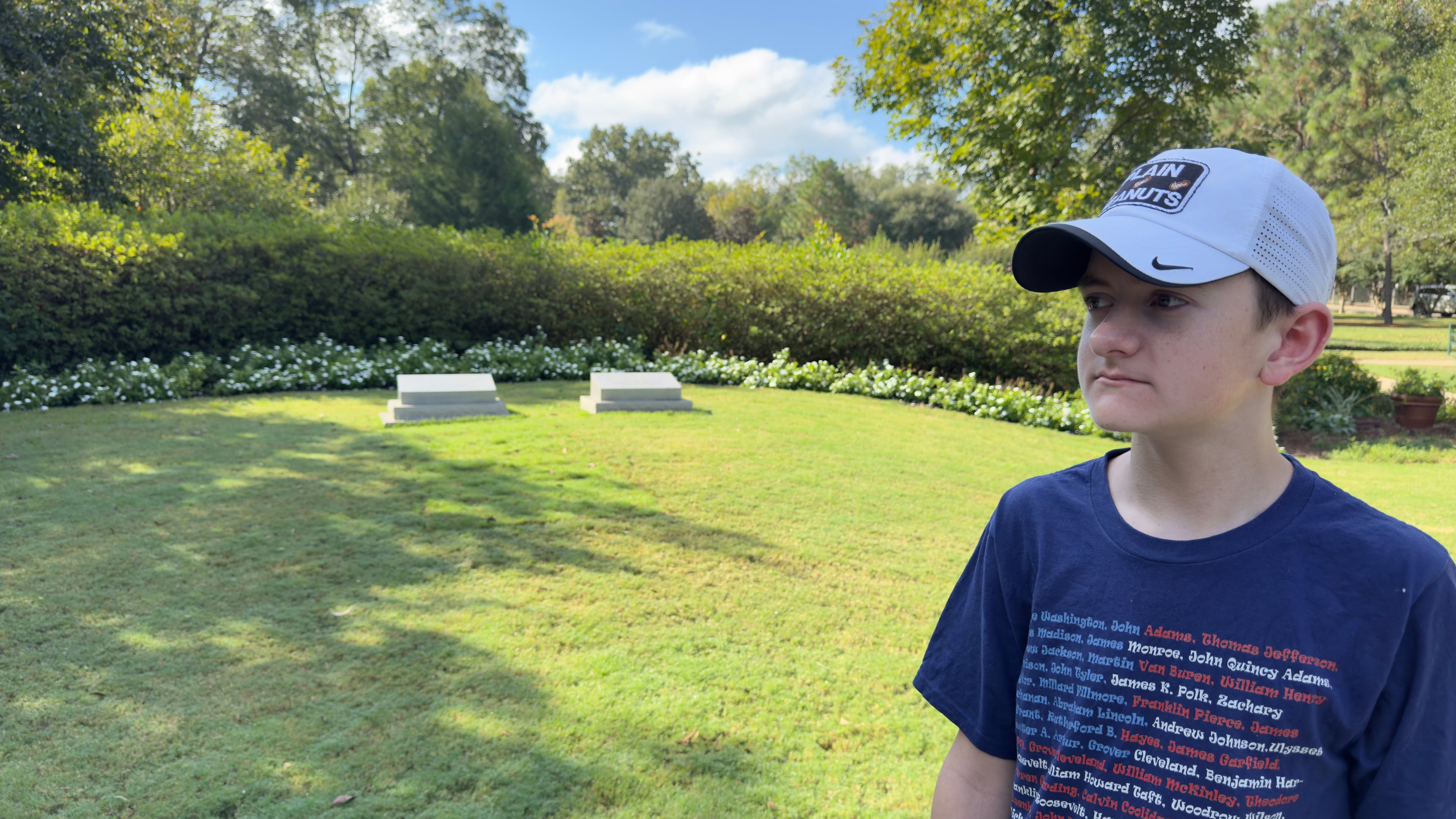 Reed Elliotte, 15, visiting the graves of Rosalynn and Jimmy Carter at the Carter Gardens in Plains. The site opened to the public in July. (Joe Kovac Jr./AJC)