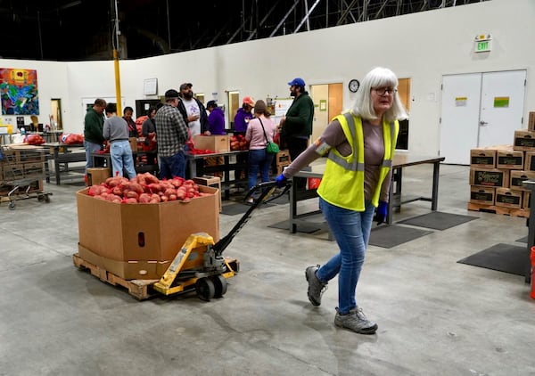 A volunteer pulls box of produce at the Alameda County Community Food Bank in Alameda, Calif., on Friday, April 25, 2025. (AP Photo/Terry Chea)