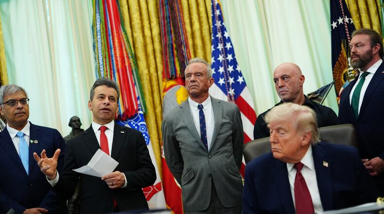 Dr. Marty Makary, commissioner of the Food and Drug Administration, speaks while, from left, National Institutes of Health Director Dr. Jay Bhattacharya, Health and Human Services Secretary Robert F. Kennedy Jr., Joe Rogan, President Donald Trump, Joe Rogan and CEO of Americans for Ibogaine W. Bryan Hubbard listen in the Oval Office of the White House, Saturday, April 18, 2026, in Washington. (AP Photo/Julia Demaree Nikhinson)