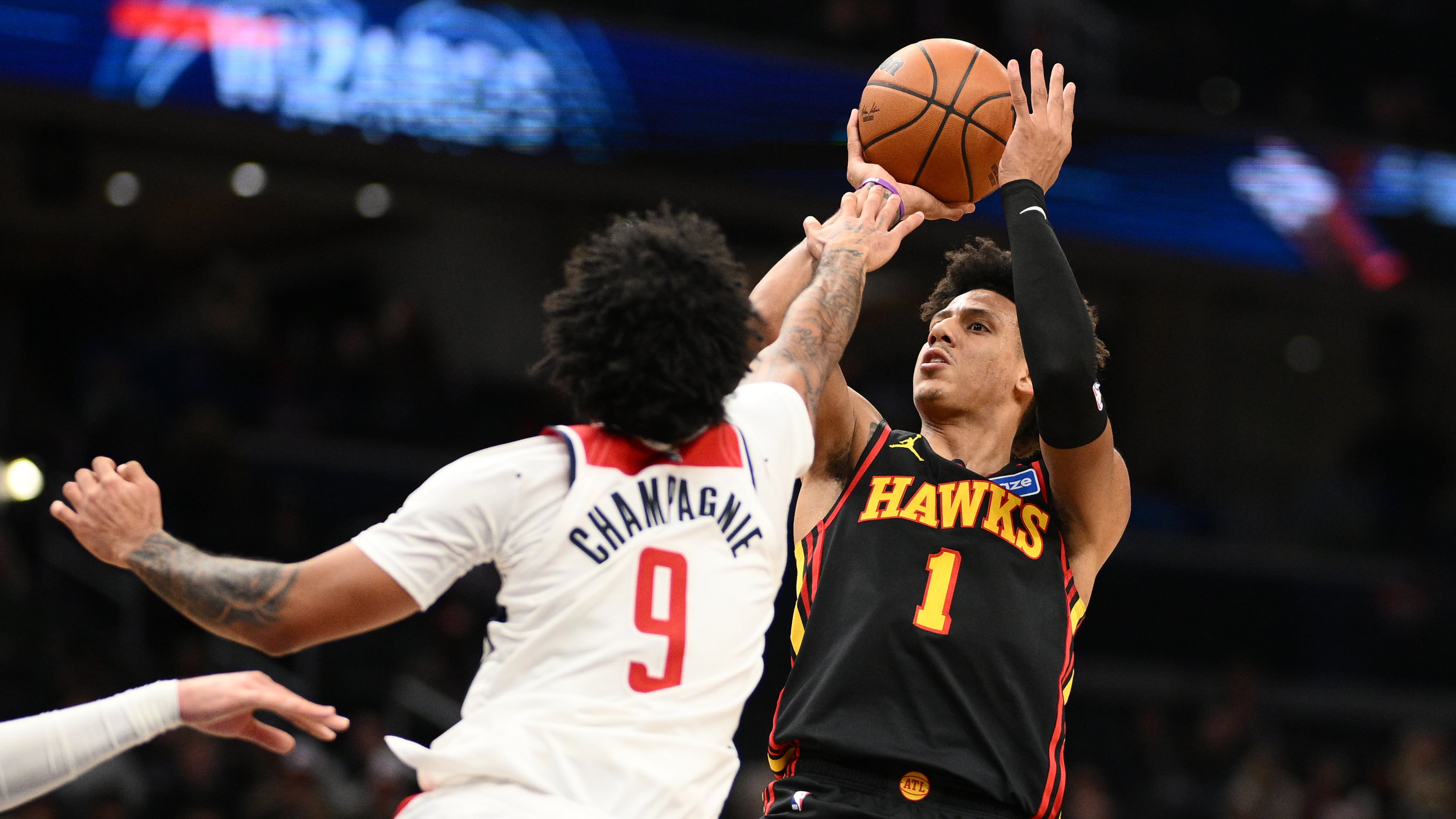 Washington Wizards forward Justin Champagnie (9) fouls Atlanta Hawks forward Jalen Johnson (1) during the second half of an NBA basketball game, Saturday, Dec. 6, 2025, in Washington. (AP Photo/Nick Wass)