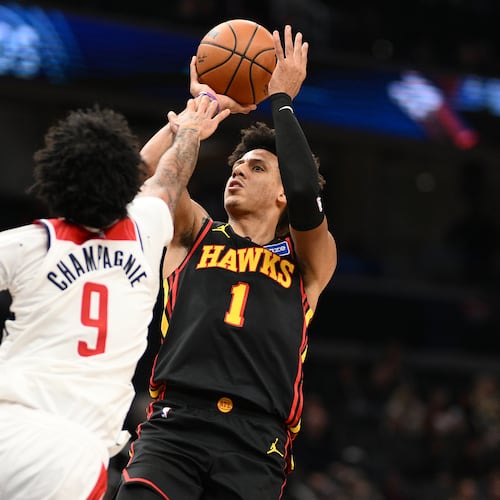 Washington Wizards forward Justin Champagnie (9) fouls Atlanta Hawks forward Jalen Johnson (1) during the second half of an NBA basketball game, Saturday, Dec. 6, 2025, in Washington. (AP Photo/Nick Wass)