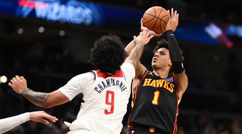 Washington Wizards forward Justin Champagnie (9) fouls Atlanta Hawks forward Jalen Johnson (1) during the second half of an NBA basketball game, Saturday, Dec. 6, 2025, in Washington. (AP Photo/Nick Wass)