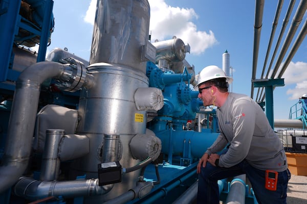 BKV Carbon Ventures project manager Spencer Crouch looks at a compression station that's part of a carbon capture and sequestration facility in Bridgeport, Texas, Thursday, May 29, 2025. (AP Photo/LM Otero)