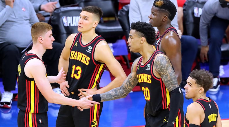 Hawks players Kevin Huerter (from left), Bogan Bogdanovic, John Collins, Clint Capela and Trae Young confer during a break of the 128-124 win over the 76ers in Game 1 of the conference semifinals Sunday, June 7, 2021, in Philadelphia. (Curtis Compton/Curtis.Compton@ajc.com)