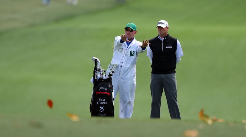 Magnolia leaves blow across the fairway as Steve Stricker and his caddie, Tommy Lamb, contemplate the approach shot on the 1st fairway. Play begins in the opening round of the 81st Masters tournament at the Augusta National Golf Club, Thursday April 6, 2017. CURTIS COMPTON/ AJC