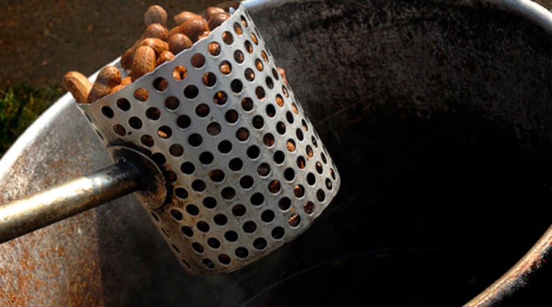 Andy Hill scoops up a serving of boiled peanuts at Sunrise Grocery and Gas in Blairsville, just north of Vogel State Park. AJC FILE