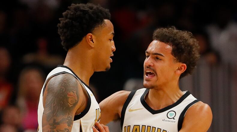 John Collins #20 of the Atlanta Hawks reacts with Trae Young #11 after dunking against Marcin Gortat #13 of the LA Clippers at State Farm Arena on November 19, 2018 in Atlanta, Georgia.  NOTE TO USER: User expressly acknowledges and agrees that, by downloading and or using this photograph, User is consenting to the terms and conditions of the Getty Images License Agreement.  (Photo by Kevin C. Cox/Getty Images)