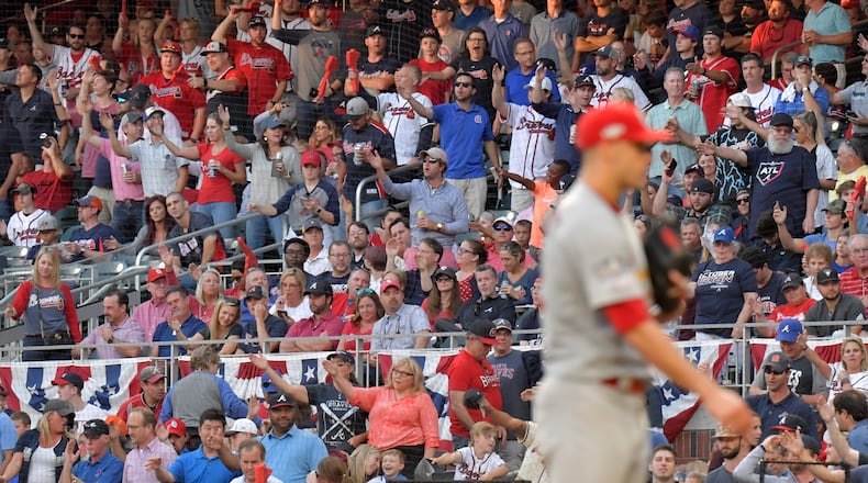 Despite the Braves’ front office not promoting the tomahawk chop in Game 5, fans did it anyway before St. Louis Cardinals starting pitcher Jack Flaherty, right, delivered a pitch in the fourth inning. HYOSUB SHIN / HYOSUB.SHIN@AJC.COM