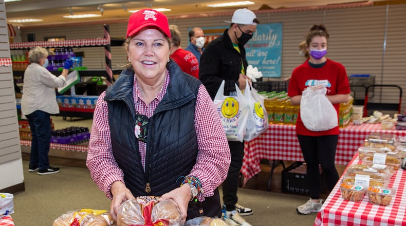 Jennifer Barnes prepares to hand out bread at the Solidarity Sandy Springs Food Pantry that serves 350-400 households per week in an old Peter Glen store at The Prado. PHIL SKINNER FOR THE ATLANTA JOURNAL-CONSTITUTION.