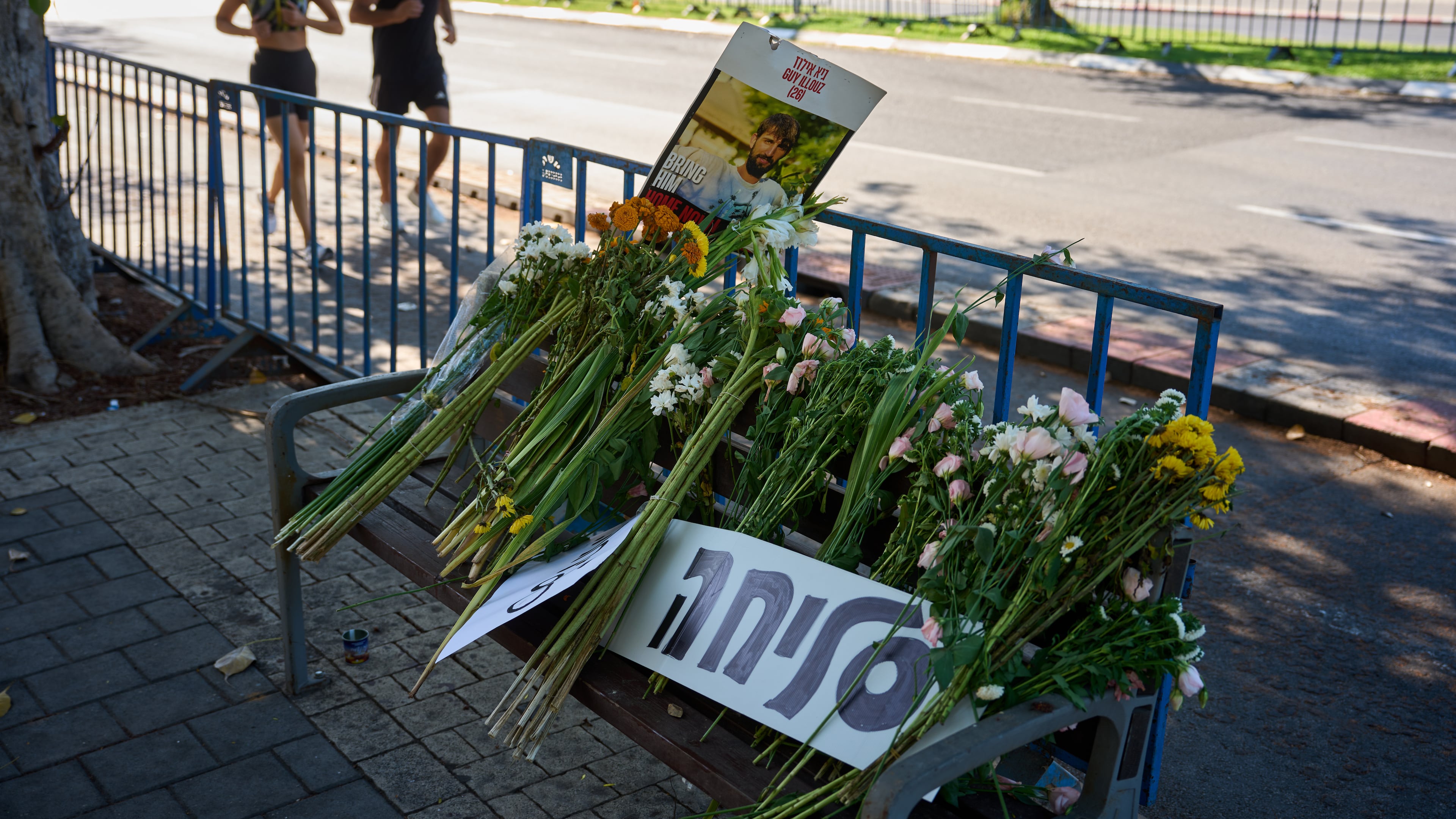 Flowers and a sign written in Hebrew reads "Sorry" are placed on a bench outside Abu Kabir, the forensic institute where the identification process is being carried out on the four bodies that were held by Hamas in the Gaza Strip, in Tel Aviv, Israel, Tuesday, Oct. 14, 2025. (AP Photo/Emilio Morenatti)