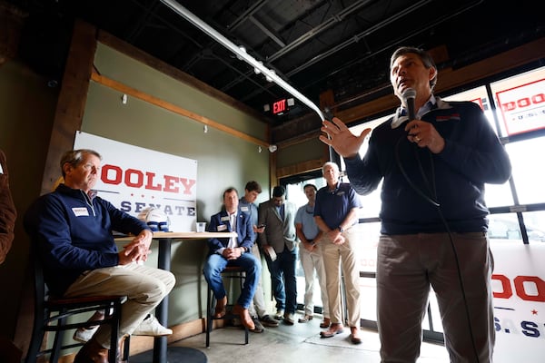 U.S. Senate candidate Derek Dooley speaks to supporters during a campaign event in downtown Carrollton earlier this month as Gov. Brian Kemp looks on. (Miguel Martinez/AJC)