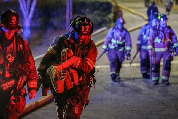 March 15, 2017: Atlanta firefighters made a long walk to the front of the property of the Venetian Hills Apartments, where a fire killed a 63-year-old man. JOHN SPINK / AJC